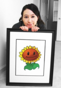 Laura Shigihara poses with a sunflower character from Plants vs. Zombies